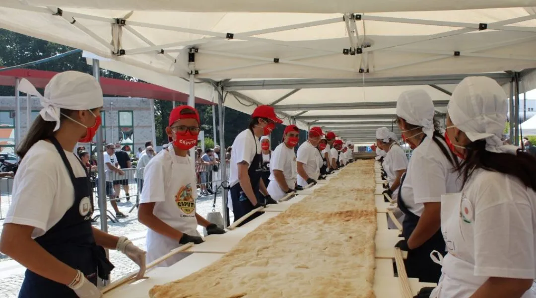 Record-breaking pizza in shovel - dough rolling - event photos